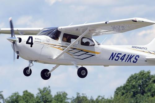 A closeup shot of a single engine plane landing at the Kent State Airport.
