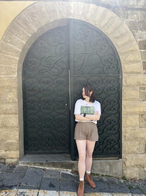 Grace posing in front of a large stone building