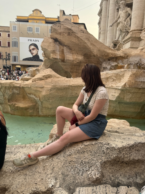 Grace sitting on a rock in Italy