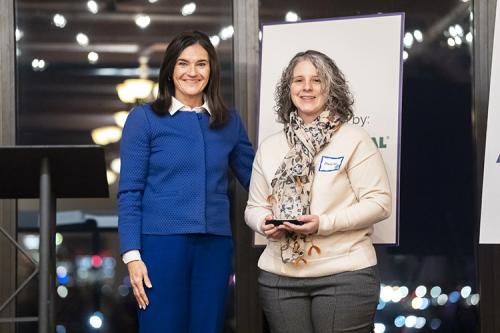 Mary Lynn Delfino (r) receives the 2026 Mentor of the Year award from Kristen Baird Adams, chairperson of the College Now Greater Cleveland board of directors.