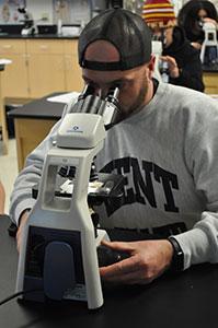 Using one of the new compound microscopes in the anatomy lab.