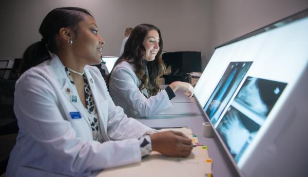 Two women looking at x-rays