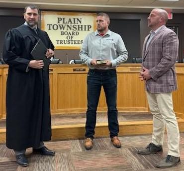 Scott Haws, '99, is sworn in for a new term as Plain Township Trustee, alongside Judge Matt Kreizter and brother Jason Haws.