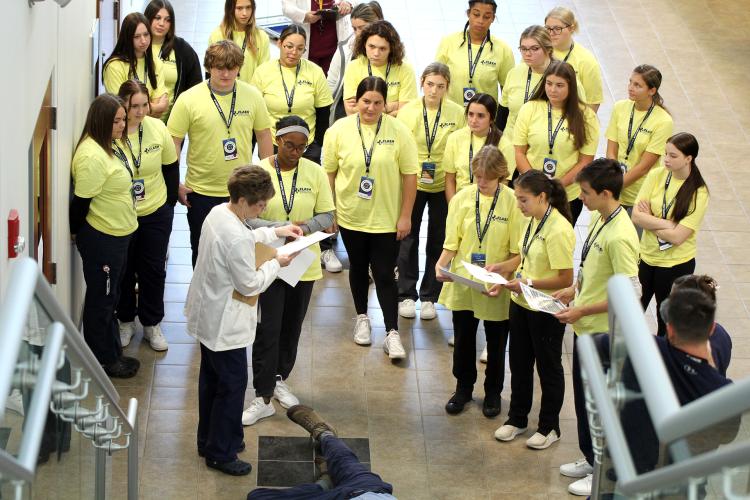 Flash Medical students assemble at the bottom of a stairwell to begin their patient accident simulation
