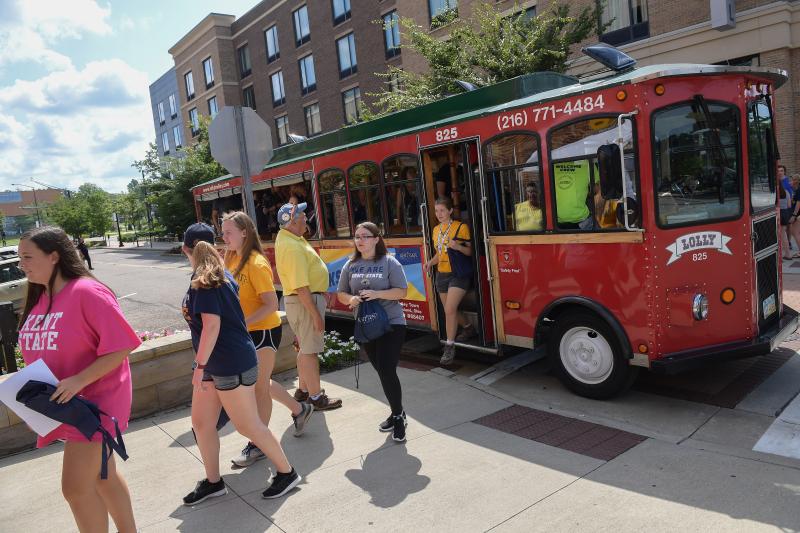 Students exit a trolly style bus ready to explore Kent.