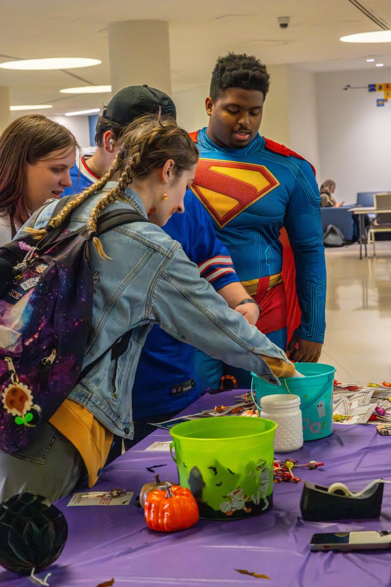 Student with superman custom getting candy