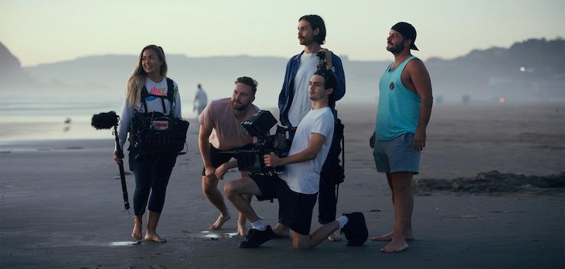 A film crew on a beach making a movie