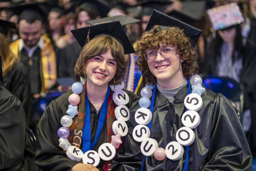 Two new Kent State graduates show their KSU pride with Taylor Swift-style "friendship" necklaces.  (Photo credit: Bob Christy, 91Թ) 