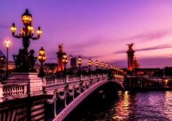 Bridge in Paris, purple sunset, in France.