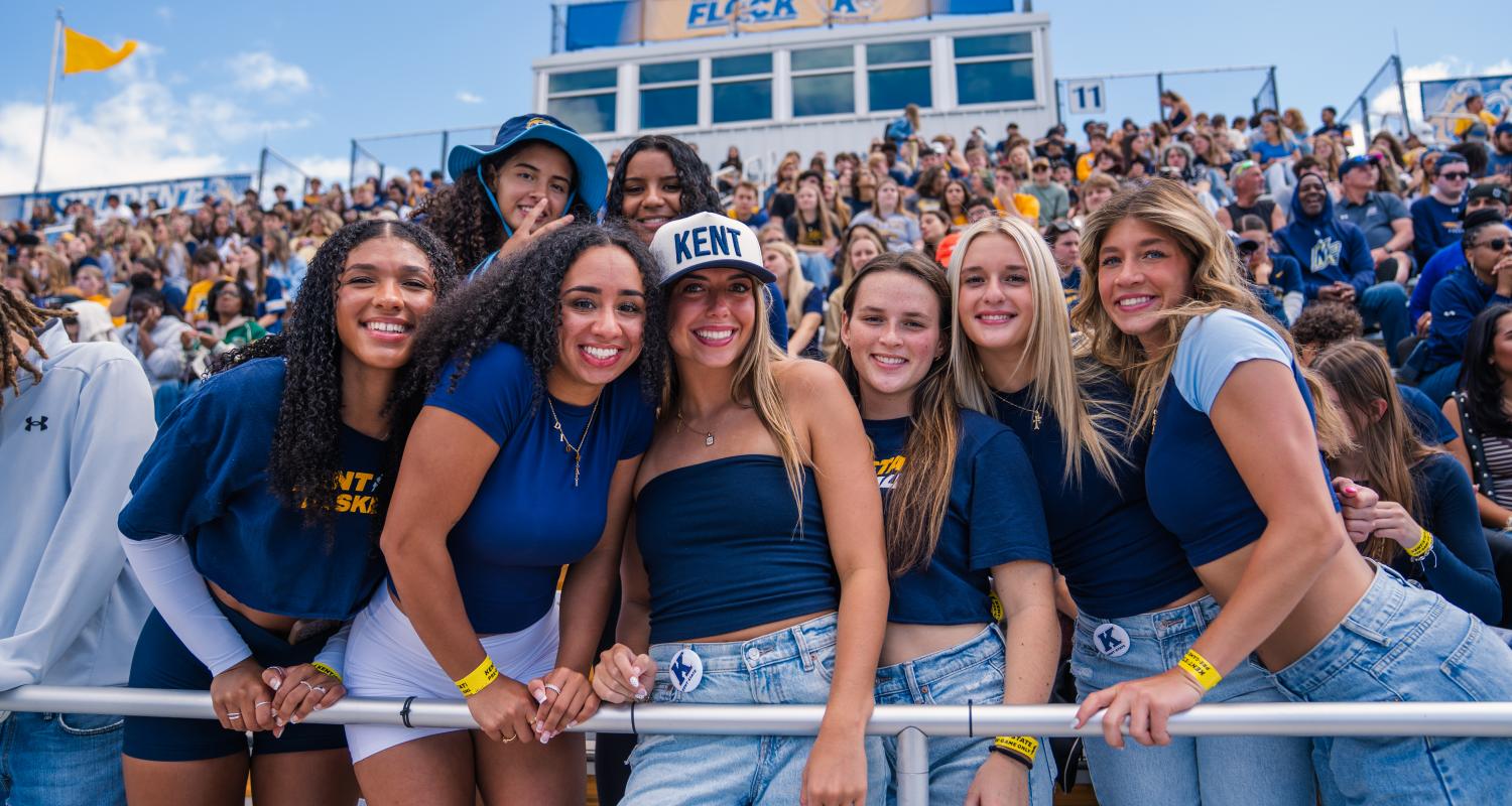 Group of students smiling at a football game