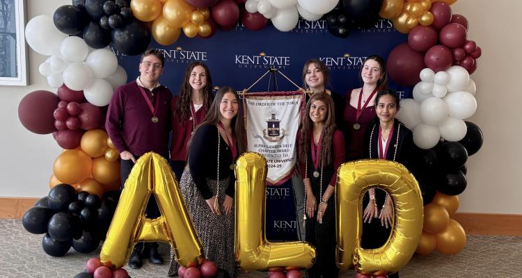 Alpha Lambda Delta officers stand for group photo with ALD shaped letter balloons.