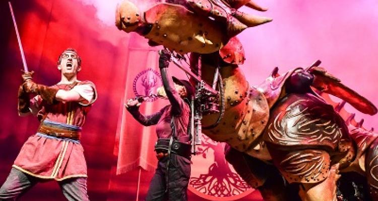 Dragons and Mythical Beast scene with actors and large dragon puppet