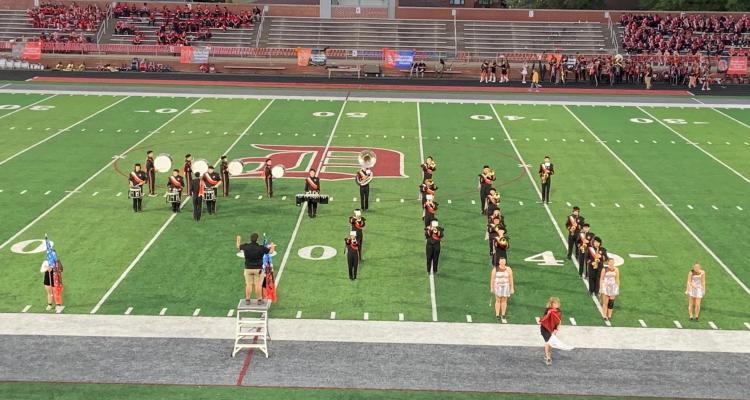 marching band performing on a football field