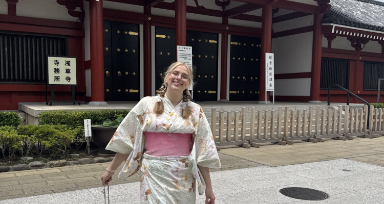 Ashley dressed in a kimono in front of a temple