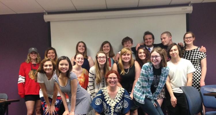 Dr. Elizabeth Howard standing with one of her Freshman Honors Colloquium classes.