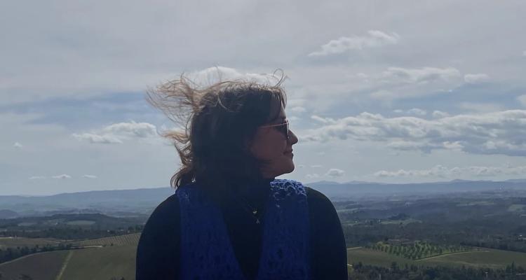 Ali at an overlook with the Italian countryside behind her.