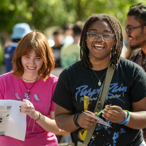 Two students smiling while standing outside at Vlogƽ’s Black Squirrel Festival.