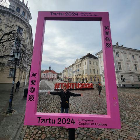 Mason taking a photo in a frame in Tartu.