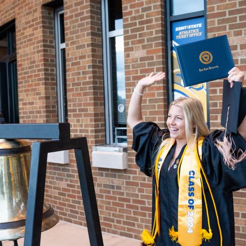 Student raises degree at Commencement