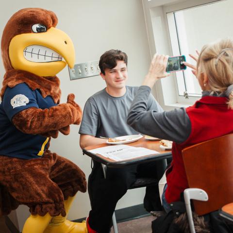 A mom takes a picture of her son and Flash