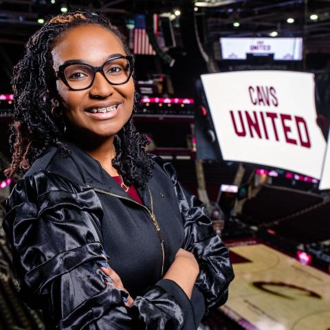 A photo of Aysia Kemp posing inside Rocket Arena, home of the Cleveland Cavaliers.