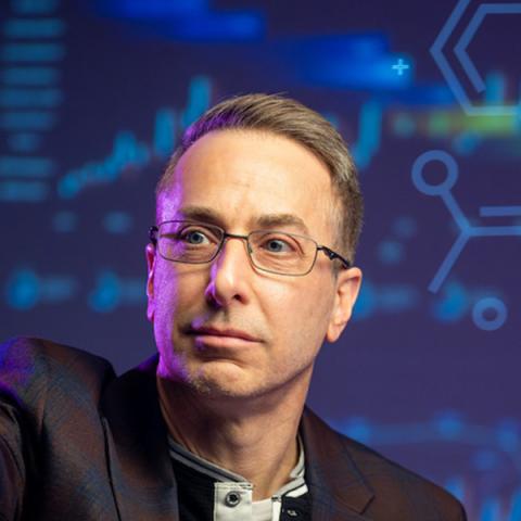 Deric Kenne, Ph.D., director of the Center for Public Policy and Health at Kent State University, reviews a map of Ohio. (Photo credit: Rami Daud, Kent State University)