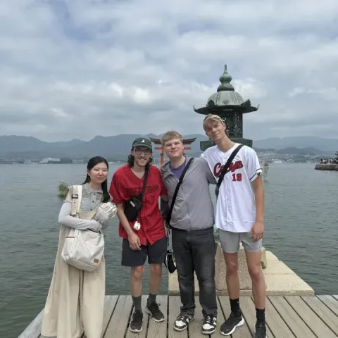 Brandon and friends in front of a torii gate.