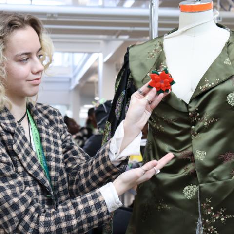 Student showcasing wearable technology on a mannequin