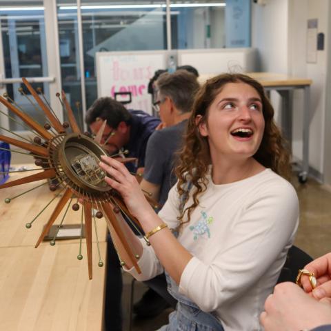 photo of student holding a clock
