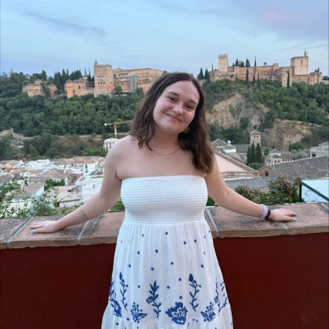 Person wearing white standing in front of city view in Spain