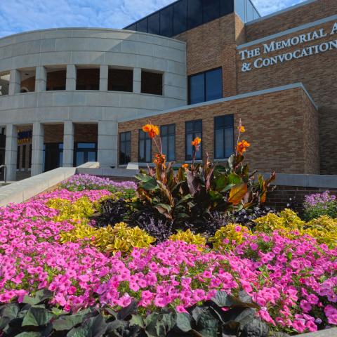 Memorial Athletic and Convocation Center with colorful flowers in front