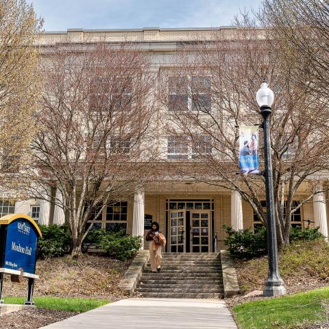 Student walking in front of Moulton Hall