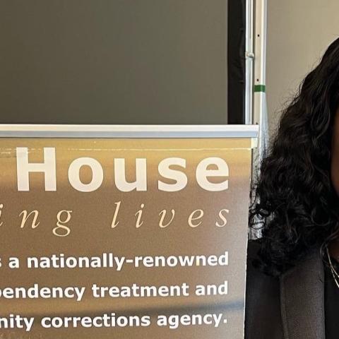 CPH alumna with Oriana House banner