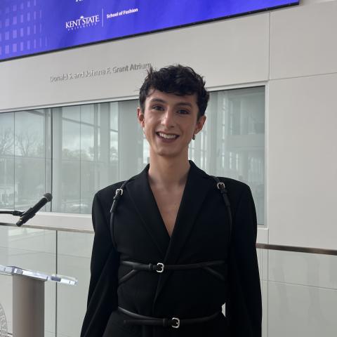 Carter Evans, the Centennial Court A Resident Assistant, wearing a black coat and smiling at the camera