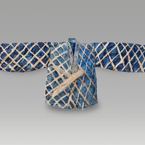 Garment laid out with arms to side; dark blue, light blue colors with a white criss cross pattern. 