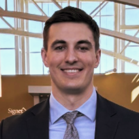 Tom Sonnanstine V at NEOMED posing with his sign that reads I matched in general surgery with Summa Health.
