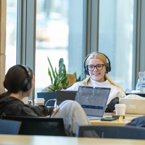 Two students sitting at a table and studying