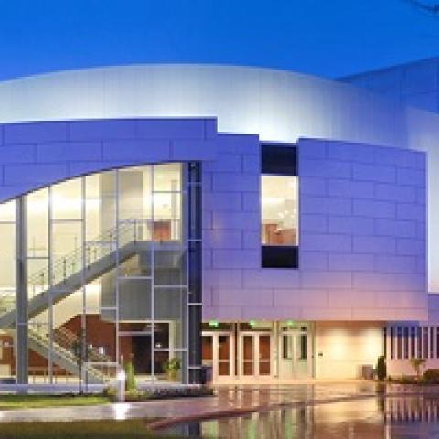 Outside picture of the front of the Performing Arts Center lit up at night