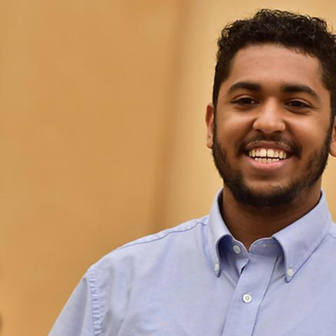Student in classroom smiling