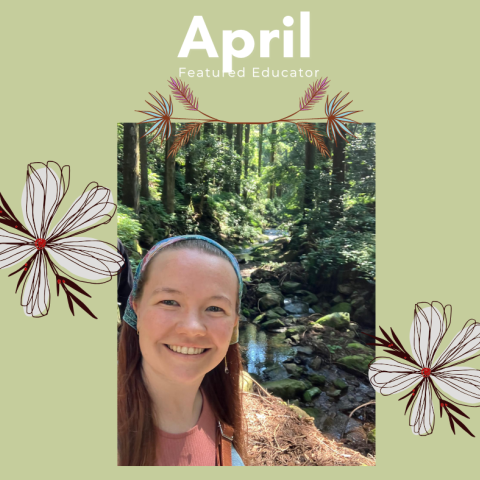 Woman standing in front of stream with flowers on background
