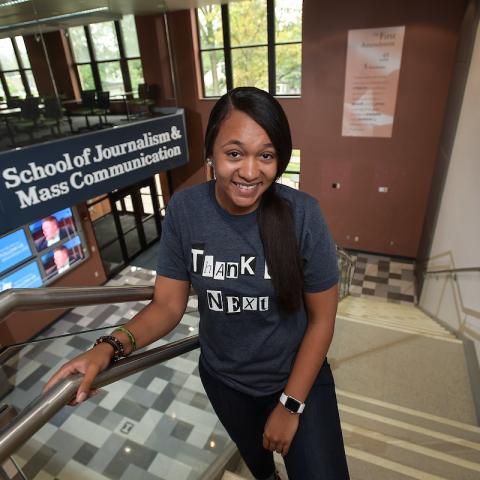 Student on steps inside Franklin Hall