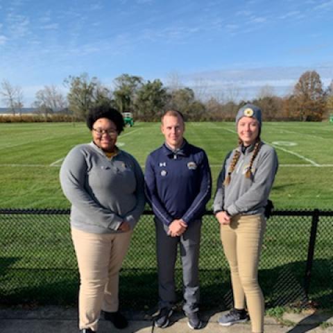 Picture of Tyler Schumak with two students.