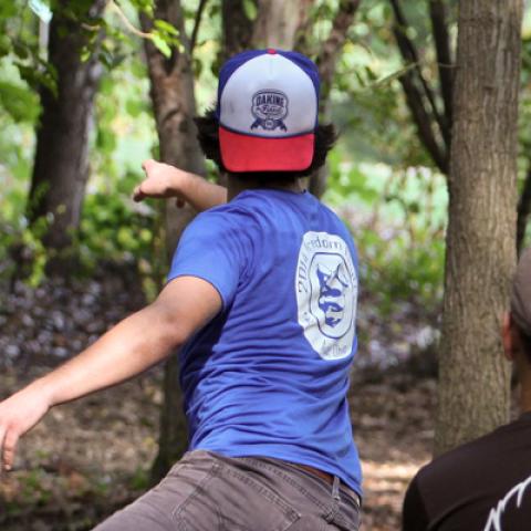 throwing disc at target in the woods