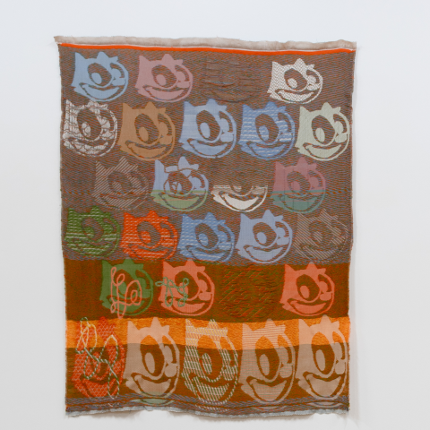 photo of a textile artwork depicting a character's likeness repeated throughout