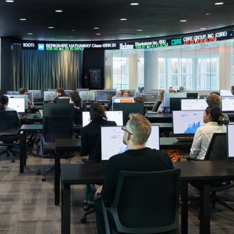 A student presents during a finance MBA class.