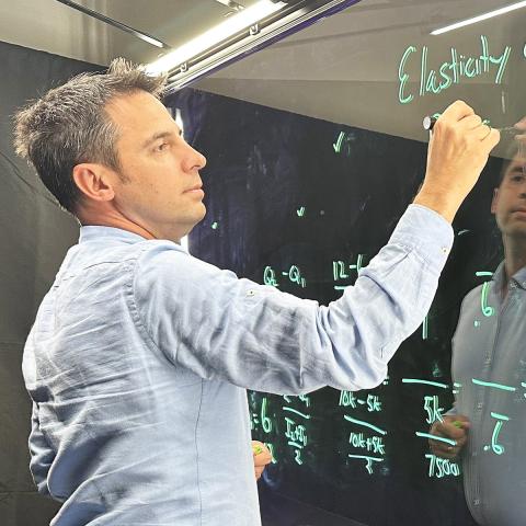 Shawn Rohlin, Ph.D., professor of economics, records a lecture for an online course in the Crawford Hall production studio.