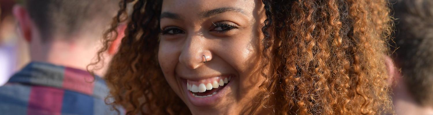 Kent State female student in dark blue shirt smiling at the camera.