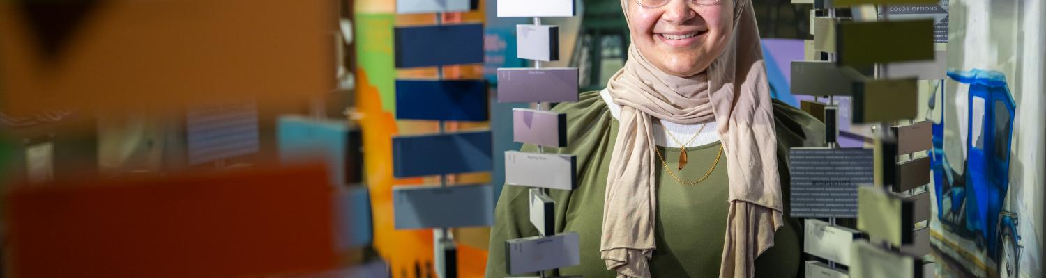 Sophia Matar amongst hanging paint color samples