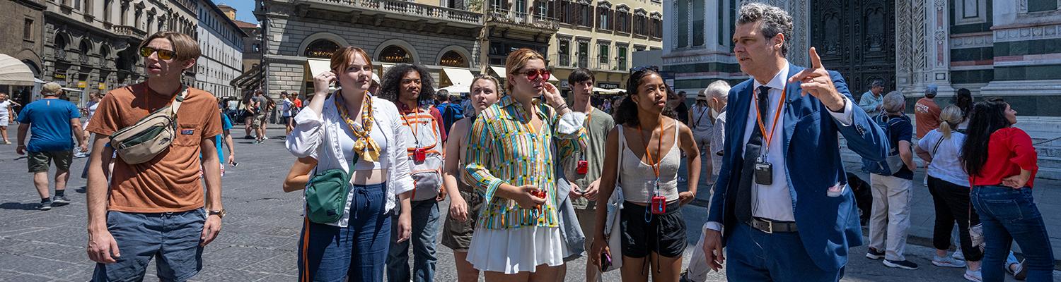 Students walk through the streets of Florence, Italy during a class.
