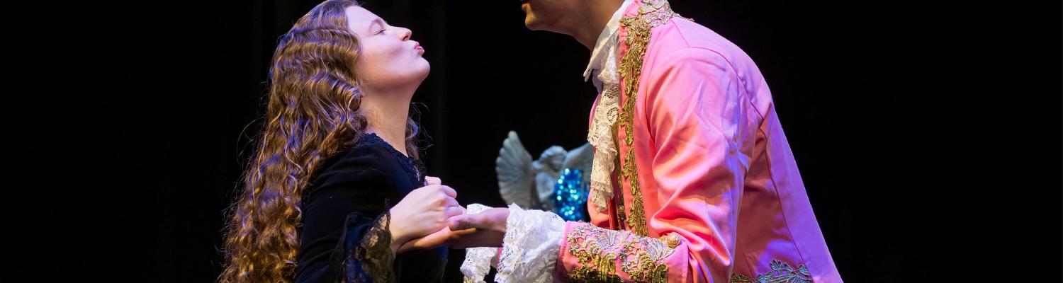Two people on stage during a KSU opera performance. 